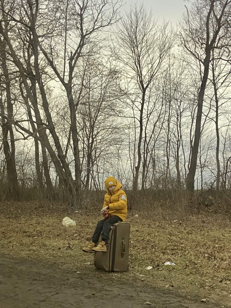 Photo: A boy on the side of a car line, 20 km to the Shehyni border crossing (author's photo)